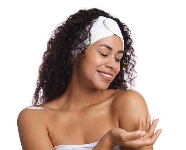 Beautiful woman with cream against white background